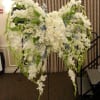 Open lattice angel wings on a standing easel.