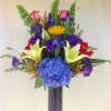 Bright and colorfull arrangement. lilies, roses, sunflowers iris hydrangeas, arranged in a
