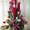 Orchid, stargazer lilies, ginger. red roses

