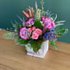 Beautiful roses, spray roses, lilies, blue thistle, wax all arranged in wooden
