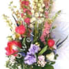 An amazing full flower arrangement with a gorgeous bow and quality vase