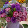 Mixed of roses, carnation, and hydrangea in a dragonfly container. A beautiful