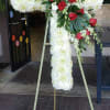This striking red and white cross honors your loved one in a