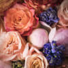 Luscious spring-colored blooms highlight this lovely and abundant arrangement. Gorgeous coral and