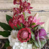This serene arrangement that includes Cymbidium Orchids, Lilies, Protea, Hydrangeas, Japonica, and
