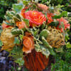 A daring yet natural bouquet of Pittosporum, Tree Ivy, Roses, and Dried