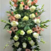 Pastel and soft, this spray has a generous number of roses surrounded