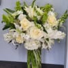 Country French arrangement with lilies, hydrangea, roses, bells of Ireland, and snap