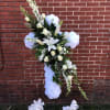 A CROSS WITH ALL WHITE SILK CARNATIONS AND AN ASSORTMENT OF FRESH