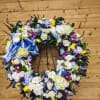 This stunning wreath is a beautiful mix of hydrangea, roses, calla lilies