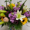 Fish bowl vase with white lily, sunflowers, pink carnations and lavender stock


