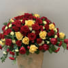 A bold mix of red and yellow roses accented by carnations, mini