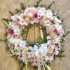 Beautiful standing funeral spray arrangement with mixed pink and white flowers with