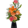 Vibrant orange blooms pop in this deep color vase. Approximately 5&quot;W X