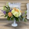 The glow of this amazing arrangement of roses, Hydrangeas, and other seasonal