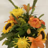 Orange  lilies and roses with yellow sunfowers and spider mums surrounded