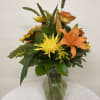 Orange  lilies and roses with yellow sunfowers and spider mums surrounded