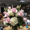 White hydrangeas, white or pink lilies,pink Roses all arranged beautifully and impressive