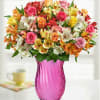 A mix of available colored roses and alstroemeria. Vase color will be