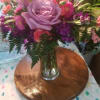 This beautiful arrangement of lavender roses, mini orange carnations, pink matsumoto asters
