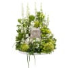 Cream and green blooms in a circular design to surround the urn