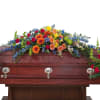 The treasured celebration trio includes a casket spray, standing easel spray and