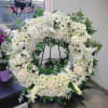 A beautiful white and green tribute wreath that calms, this easel arrangement