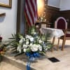 White and blue sympathy flooor basket with a blue ribbon 