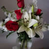 Red roses combined with white lilies and stock not only smells great