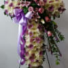 Beautiful standing cross in whites, lavender daisies, lavender roses and stargazer lilies