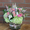 Pinks, greens, whites and peache colors in a large cylinder vase accented