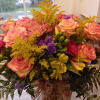 Very large vase of fall flowers with a dozen bicolor orange and
