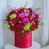 This arrangement in a hatbox in a red palette is a composition