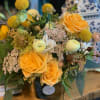 Filled with bright yellow and orange tones, this sunny arrangement will be