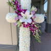 A cross wreath featuring white chrysanthemums, lilies, roses, dendrobium orchids, and mixed