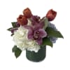 Mix of Tulips, Roses, Hydrangeas and Cymbidium orchids arranged in a Cilinder.