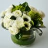 an elegant flower arrangement of white ranunculus and beautiful white anemones with