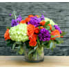 This bright and vibrant arrangement will liven up any room. Orange roses