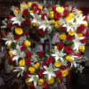 A red, yellow, and white open heart sympathy arrangement. 

*Picture is showing