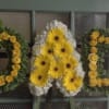 A beautiful standing arrangement spelling out &quot;DAD&quot;.

Flower selection subject to availability.