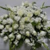 Casket spray of all white hydrangea, roses, stock and snap dragons