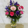 This glorious bouquet of luxurious purple, pinks and other blooms is a