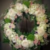  This eternity wreath is a uplifting tribute
of spring flowers.
