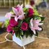 This colorful, spring bouquet contains lilies, spray roses, and hydrangea. It is