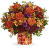 This radiant arrangement includes orange roses, light orange alstroemeria, purple button spray