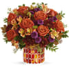 This radiant arrangement includes orange roses, light orange alstroemeria, purple button spray