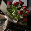 Hand bouquet of red roses and fillers