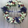 A gorgeous red, white and blue sympathy display wreath, with flowers such