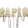 This funeral arrangement is a 5 letter piece. Could spell anything with