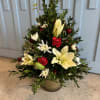 Christmas tree shaped arrangement with fresh greens and flowers. Approximately 12&quot; to